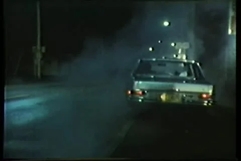 Rear view of car driving down road and fading into the distance Stock Footage 11354330