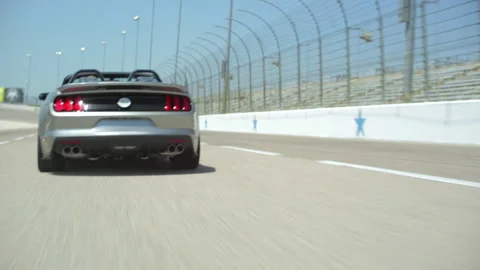 Rear view of car speeding on racetrack Stock Footage 194089247