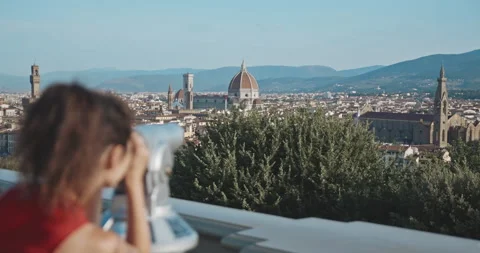 Rear view of charming young asian brunette looking through binoscope at the Stock Footage 135059094