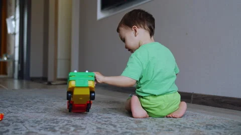 Rear view of a child playing on the floor. Stock Footage 242731038