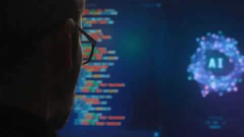 Rear view closeup of developer using AI Assistant for vibe coding on big screen. Stock Footage 341679930