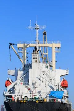 Rear view of container ship bridge against clear blue sky Stock Photos