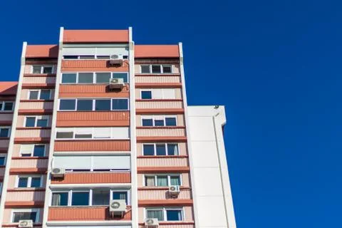 A rear view corner shoot of a tall building with blue background Stock Photos