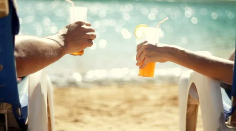 Rear view of a couple having drinks by the pool  Stock Footage 1068180