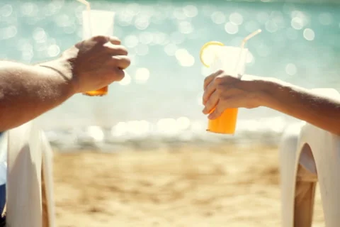 Rear view of a couple having drinks by the pool  Stock Footage 1068182