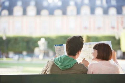 Rear View Of Couple Looking At Map In Park Foto stock