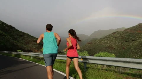 Rear View Of Couple Running Jogging Towards Mountain - STEADICAM Stock Footage 54079438