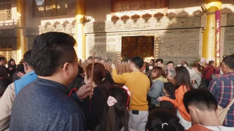 Rear view of crowd praying with incense inside temple in Taichung, Taiwan Stock Footage 313628775