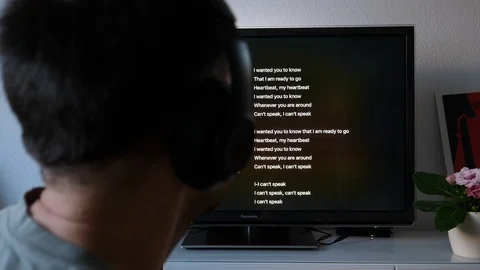 Rear view Dancing Reading lyrics and listening to Apple Music dancing - Rear Stock Footage 124799815