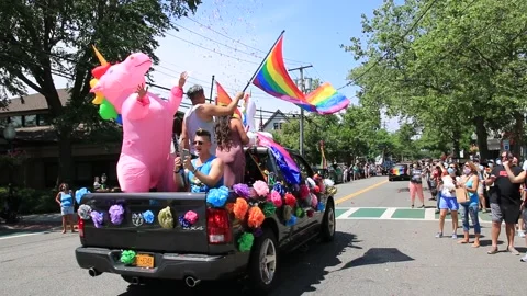 Rear view of dancing unicorn on back of truck during Gay Pride car parade in Stock Footage 135969341