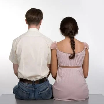 Rear view of dates sitting next to each other over white background Fotos Stock