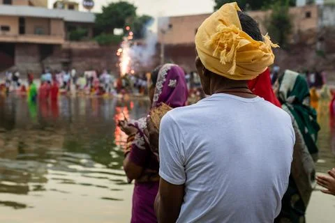 Rear View Of Devotee Praying During Traditional Chhath Puja At Sacred River.. Stock Photos