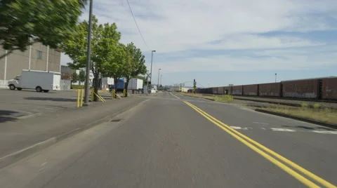 Rear view of a Driving Plate: Car travels from the mid-4300 block on NW Front Stock Footage 59310757