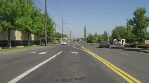 Rear view of a Driving Plate: Car turns left onto Vaughn Street in Portland, Stock Footage 59318104