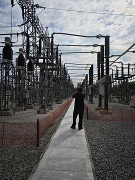 Rear view of electrical engineer worker taking photo picture. Stock Photos