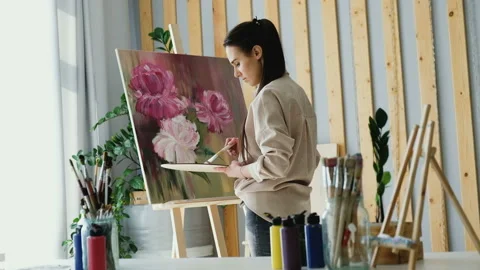 Rear view of an elegant young beautiful girl professional artist Stock Footage 110703043