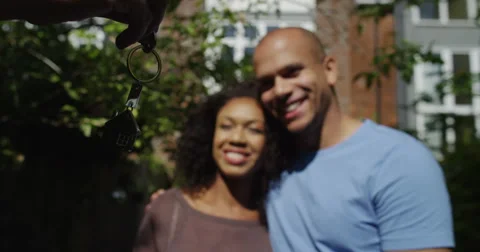 Rear-view of an embracing couple looking at their new home proudly. Stock Footage 54599050