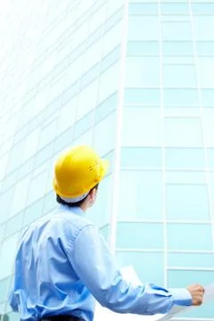 Rear view of engineer looking at office building Fotos de archivo