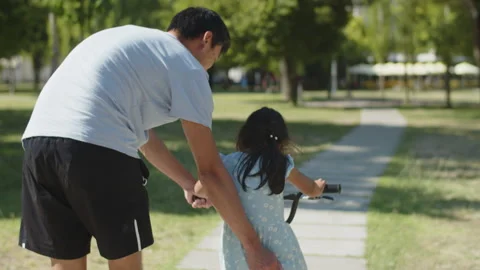 Rear view of father teaching his Stock Video Pond5