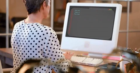 Rear view of female executive working on computer at desk Video stock 76233369
