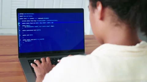 Rear view of a female programmer, using laptop, types text, writes computer Stock Footage 205103404