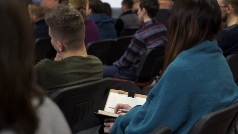 Rear view of a female using notebook at the conference Stock Footage 87956039