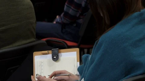 Rear view of a female using notebook and mobile at the conference Stock Footage 87956079
