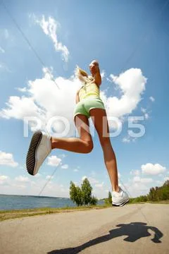 Rear view of a girl jogging energetically Stock Photos