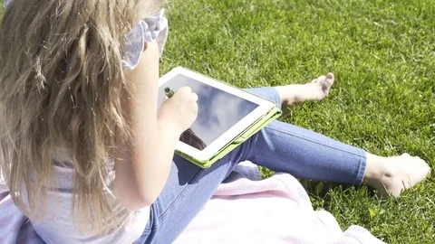 Rear view of a girl with a tablet computer 스톡 동영상 79460089