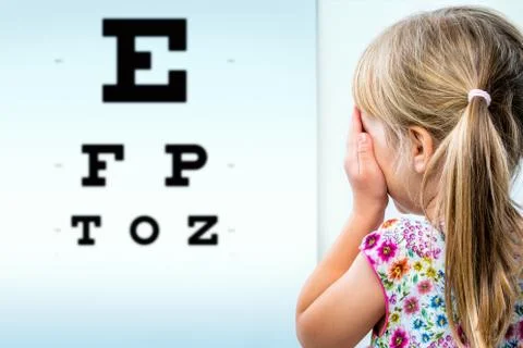 Rear view of girl testing eyesight. Stock Photos