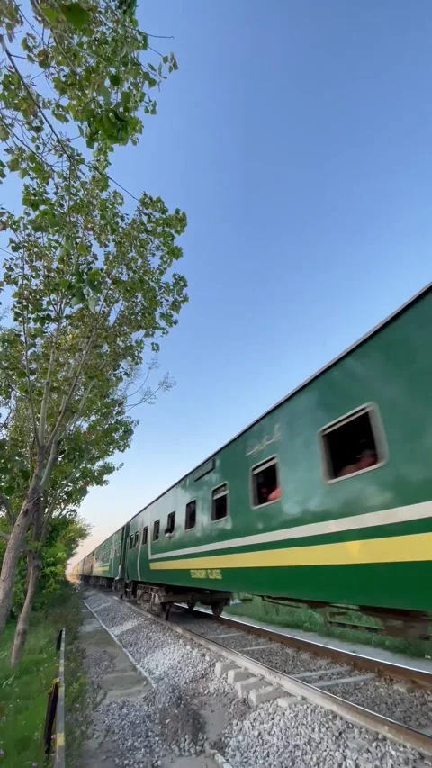 Rear view of a Green Passenger Train moving through Islamabad 스톡 동영상 343622428