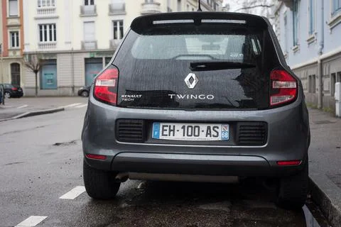 Rear view of grey Renault Twingo 3 parked in the street by rainy day Stock Photos