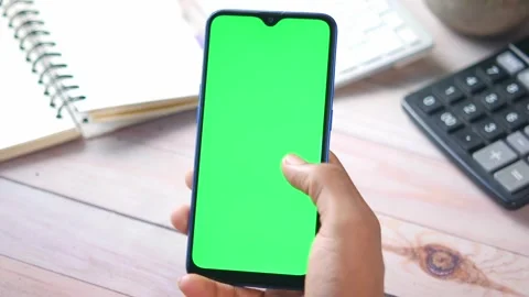 Rear view of hand hold g smart phone on office desk Stock Footage 165217860
