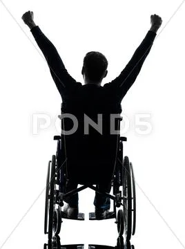 Rear view handicapped man arms raised in wheelchair silhouette Stock Photos