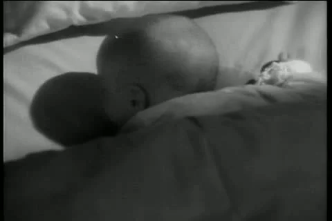 Rear view of infant turning head  in bed Stock Footage 11353170