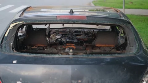 Rear view of the interior of a car burned to the ground, close-up Stock Footage 274991648