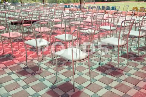Rear view of the iron chairs . Empty chairs back view of an auditorium in a s Stock Photos