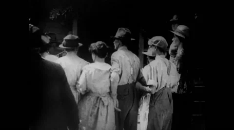 Rear view of large group of curious people assembling outdoors, 1920s Stock Footage 58858543