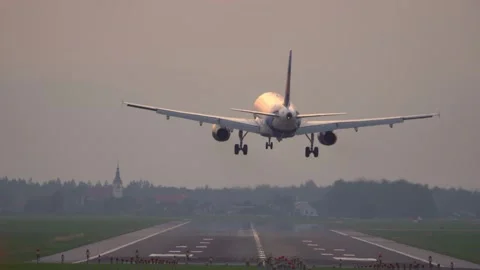 Rear view of a large passenger airplane landing on a long runway Stock Footage 245448955