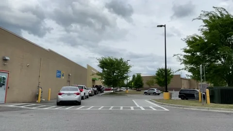 Rear view of long lines at the Walmart neighborhood drive thru on Tobacco Roa Stock Footage 152432410