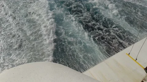 Rear view looking down at ocean waves wake trail behind luxury nautical Stock Footage 157108597