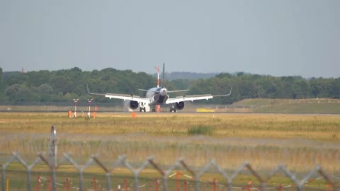 Rear view of Lufthansa passenger airplane vacating the runway Stock Footage 249679047