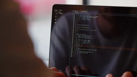 Rear view of a male developer writing code for a website. The programmer works Stock Footage 237033615