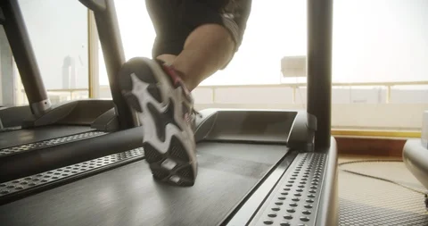 Rear view of male legs doing cardio workout on a treadmill in gym Stock Footage 123531724