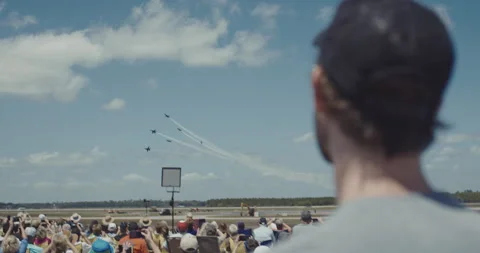 Rear view of man and crowd of people watching blue angels airplane show Video stock 147115821