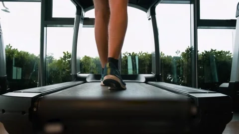 Rear view of man doing cardio training in fitness studio in residental building Stock Footage 282923420