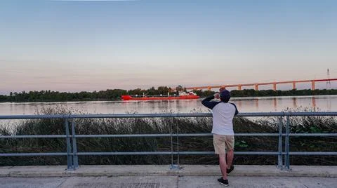 Rear view of a man drinking beer looking the river Stock Photos
