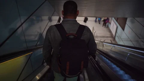 Rear view of a man  on the Escalator. Subway. Backpack. Stock Footage 104438680