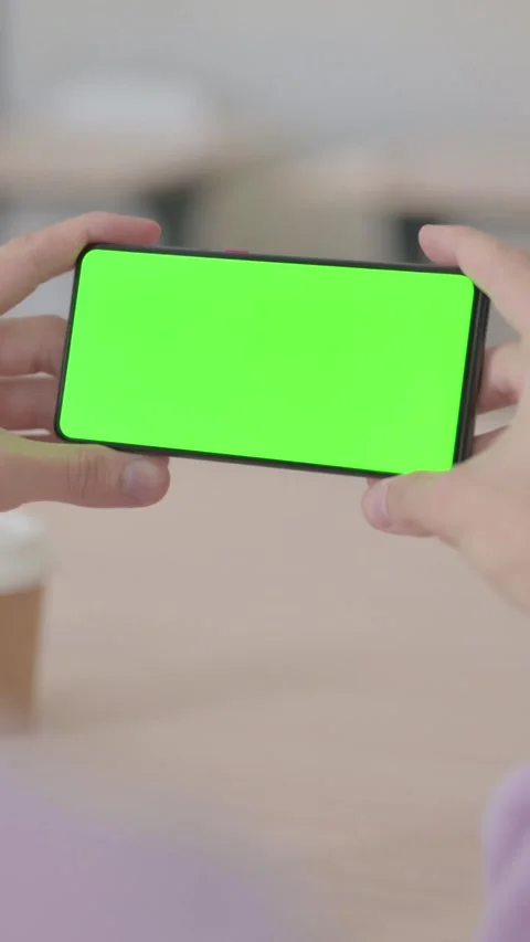 Rear View of Man Holding Smartphone with Green Chroma Screen, Vertical Video Video stock 328972021