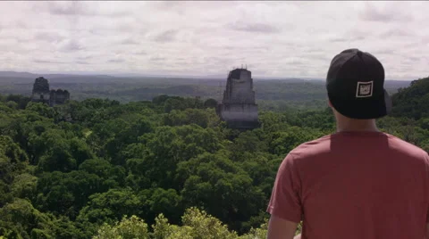 Rear view of a man looking at Tikal ruins, Guatemala Stockbeeldmateriaal 63053262